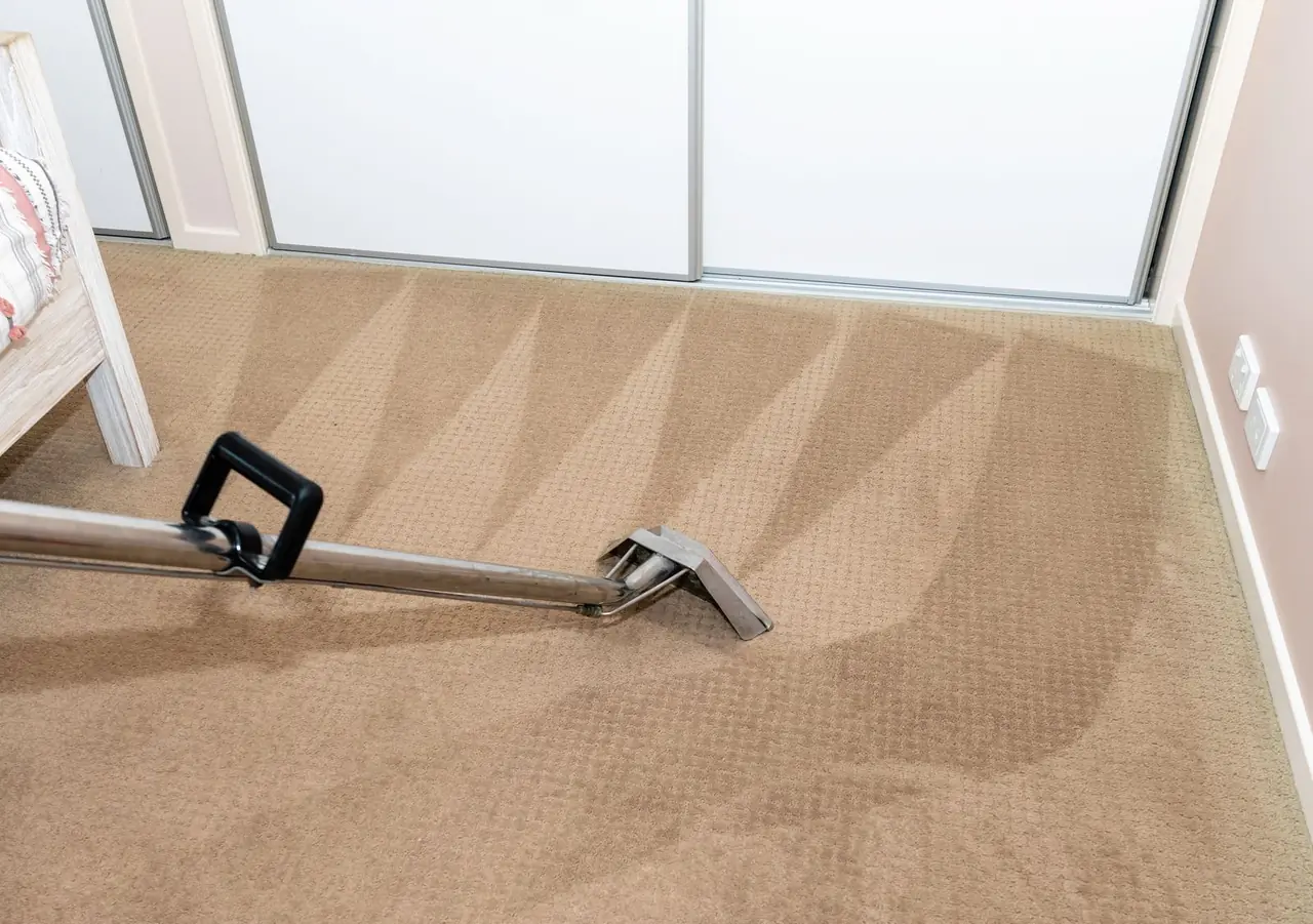 Carpet cleaning machine working across a carpeted floor